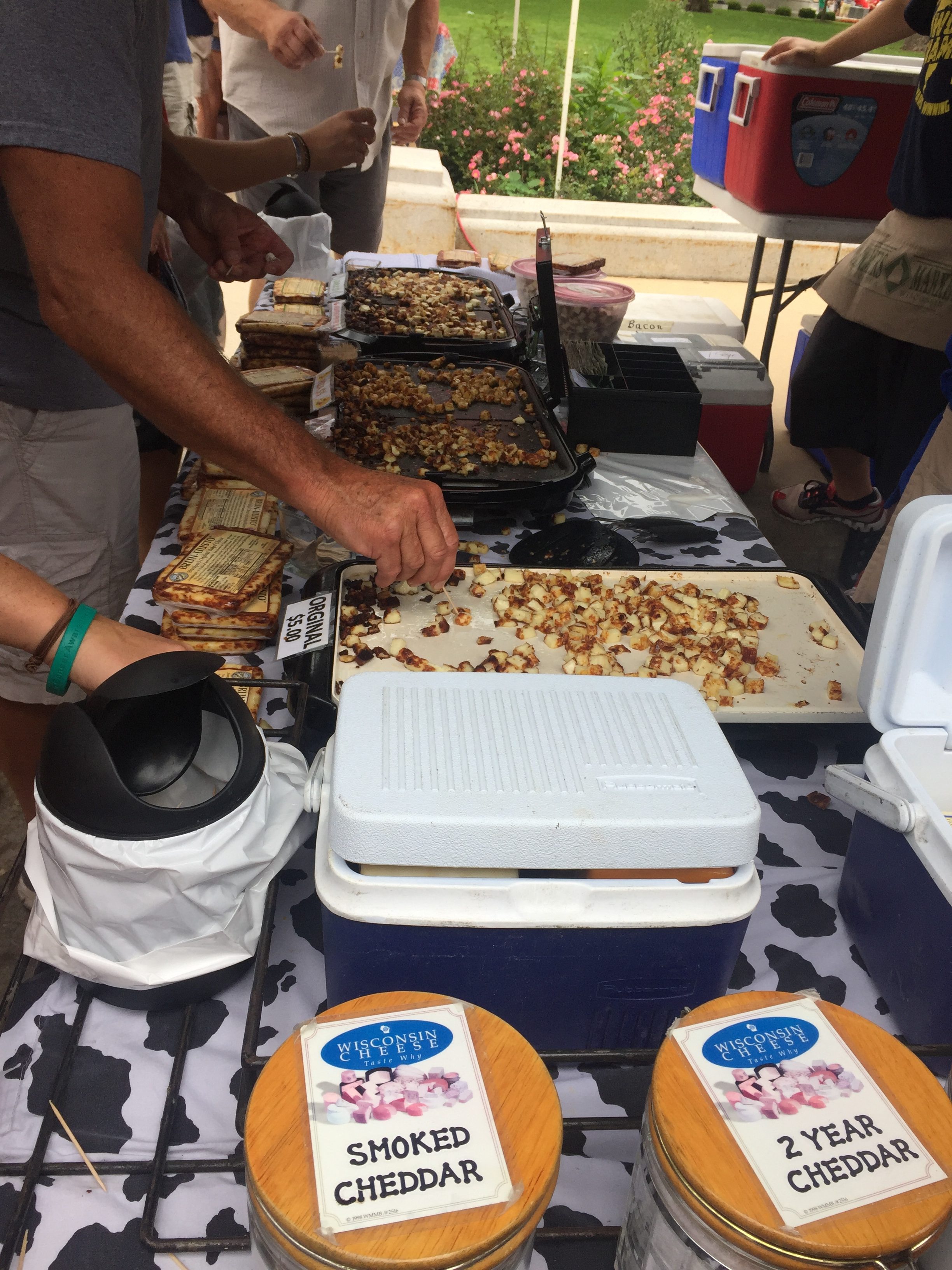 Sampling heated cheese at local farmers market. 